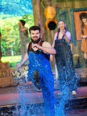 A cast member kicks up water in part of the new splashing fun segment at the Hatfield and McCoy Dinner Feud in Pigeon Forge, TN