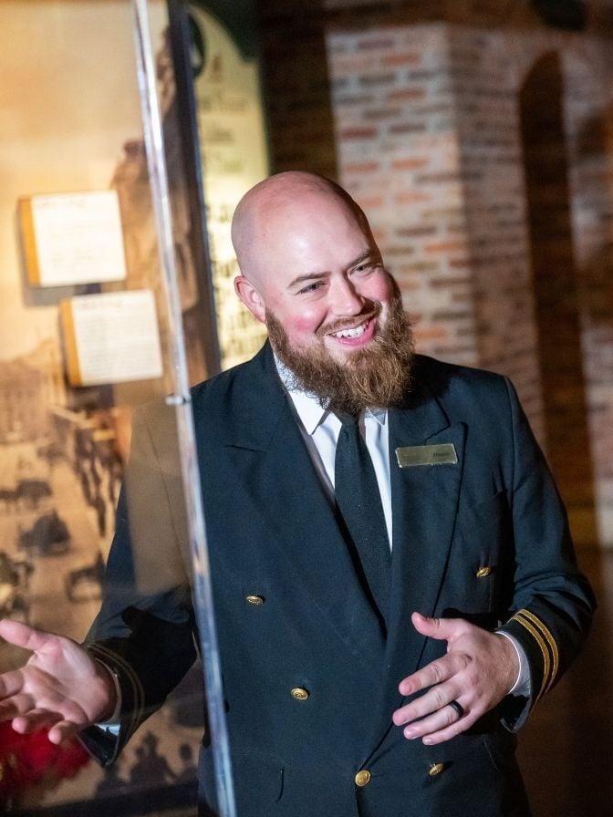 Titanic-Crew-Member-at-Case-with-Guests