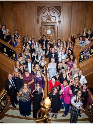 A group on the grand staircase at the corporate rental event
