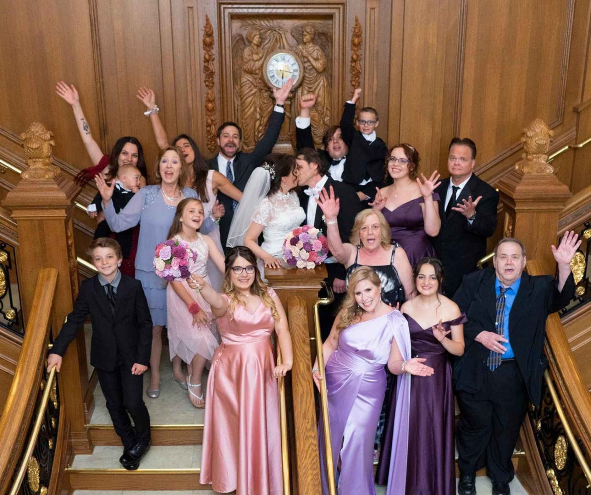 a group on the Grand staircase after a couple takes their vows