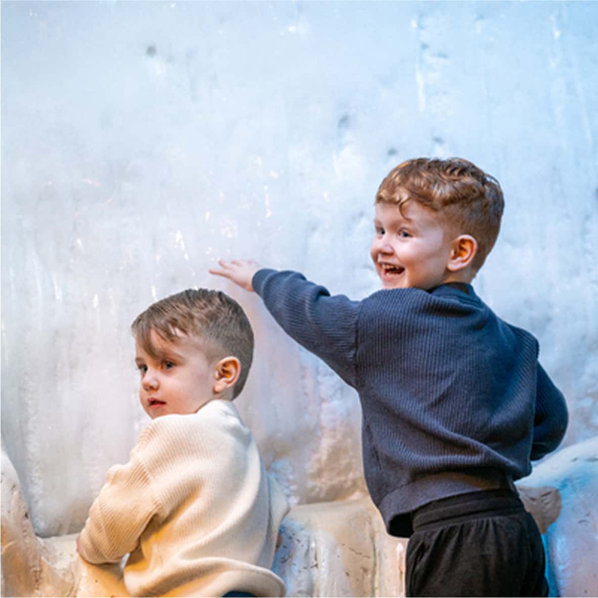 kids touching iceberg