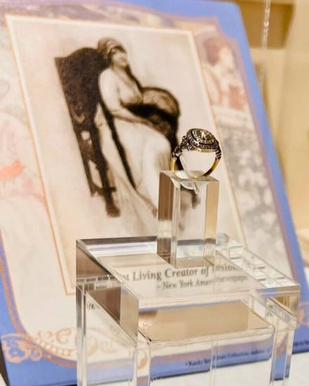 The Titanic Ring, owned by Lady Duff-Gordon sitting in front of a picture of her